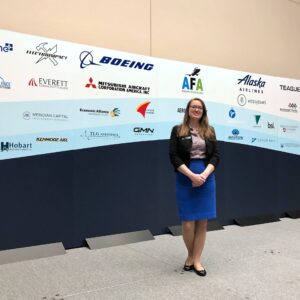 Brianna Karle in front of one of the backdrops she created for the Aerospace Futures Alliance Annual Aerospace Summit